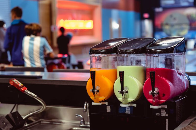Image of 3 fruit-infused beer slushies on tap in a brewery